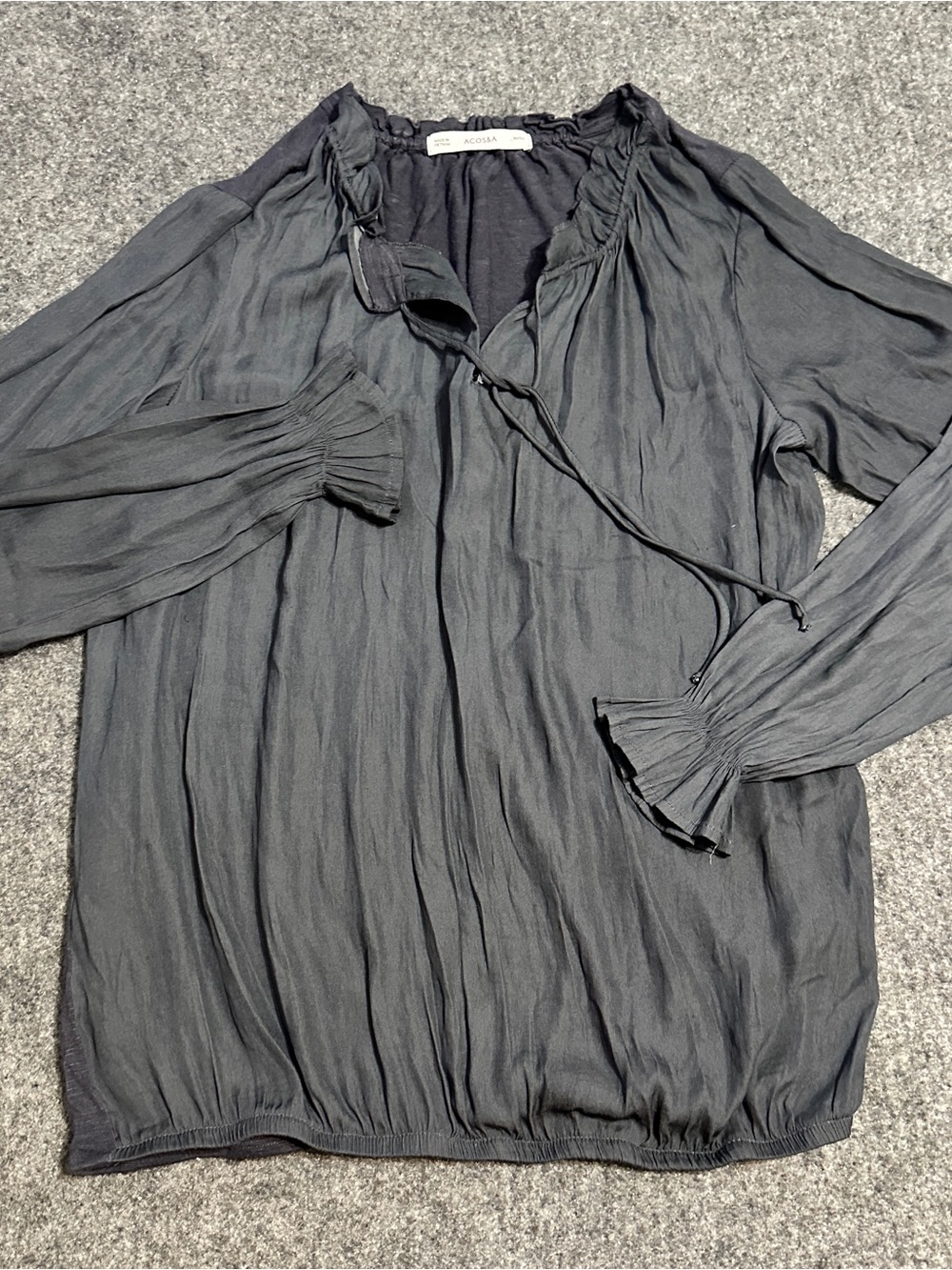 Black peasant-style blouse from the brand Acosta featuring a ruffled split neckl